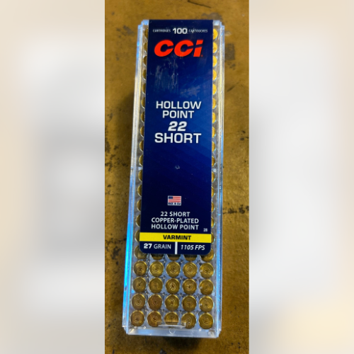 Clear plastic container of CCI .22 Short hollow point ammunition. Blue label shows details like 