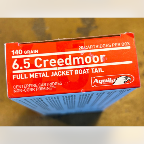 Box of 6.5 Creedmoor cartridges with red packaging. Text highlights 