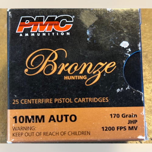Box of PMC Bronze ammo with 25 10mm Auto centerfire pistol cartridges, 170 grain, JHP. Orange and black design; warning: keep out of reach of children.
